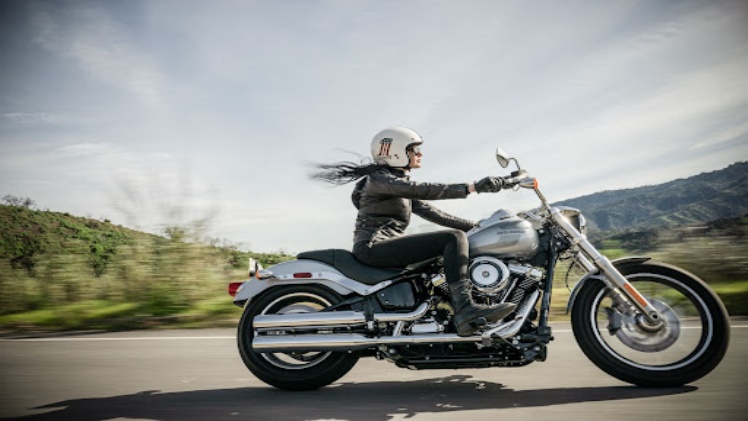 image of a woman riding a motorcycle